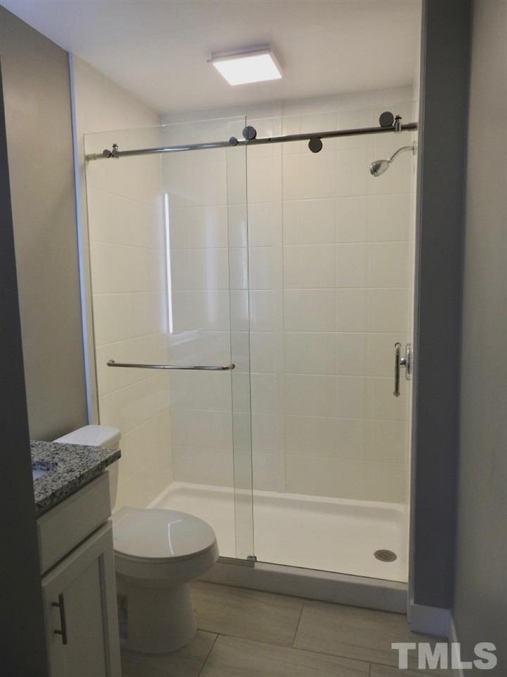 41 Peace Street Roxboro, NC 27573 - Photo 16 of 20 a bathroom with a shower and a tub