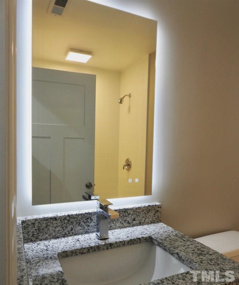 41 Peace Street Roxboro, NC 27573 - Photo 17 of 20 a bathroom with a granite countertop sink and a mirror