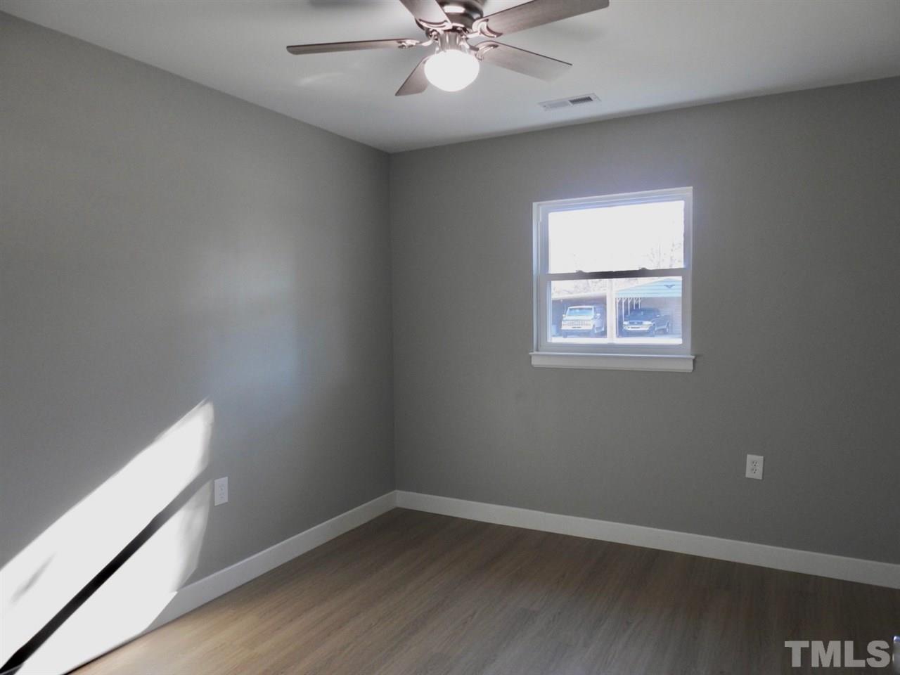 41 Peace Street Roxboro, NC 27573 - Photo 18 of 20 an empty room with wooden floor and windows