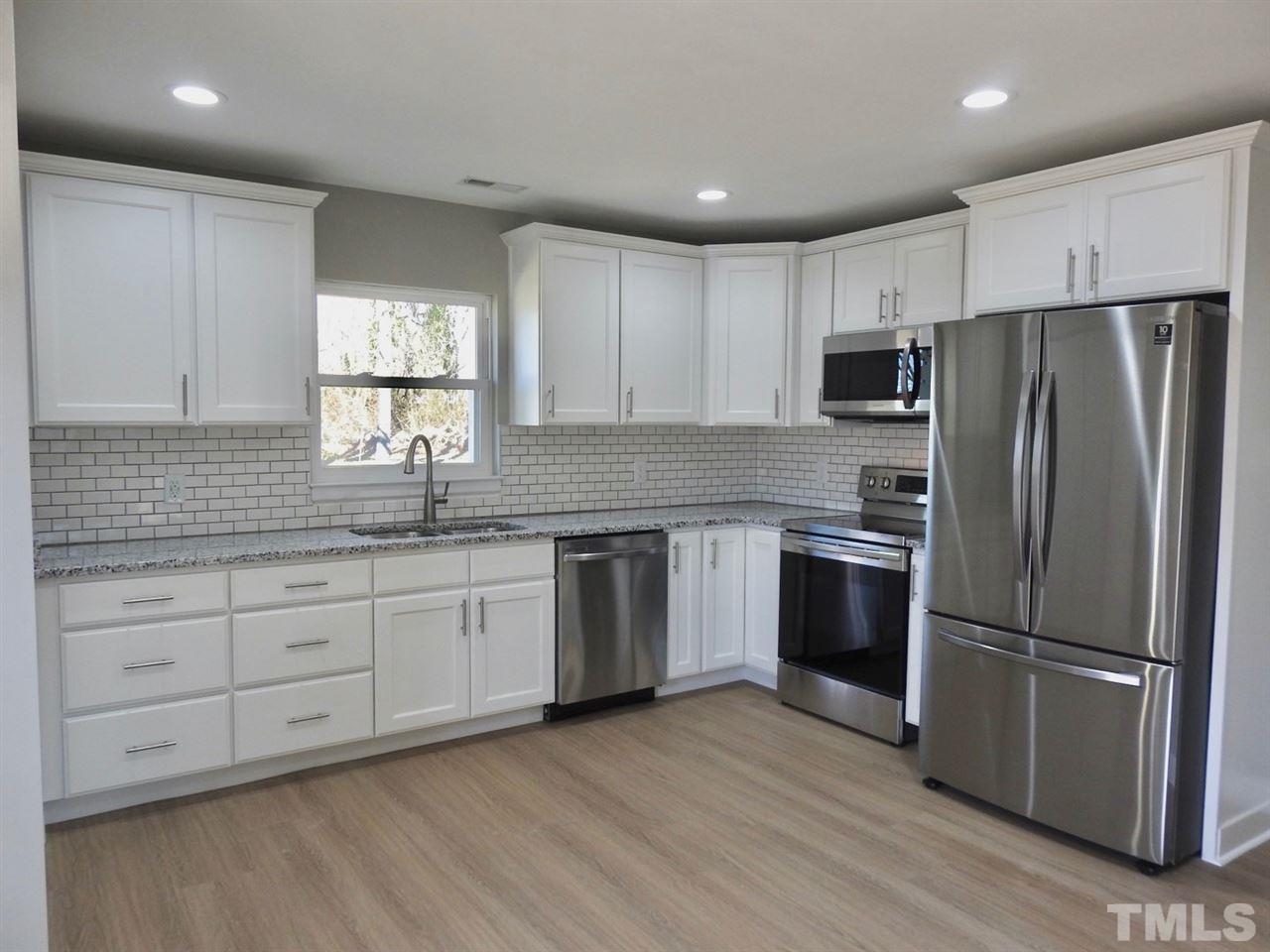 41 Peace Street Roxboro, NC 27573 - Photo 5 of 20 a kitchen with stainless steel appliances granite countertop a refrigerator sink and cabinets