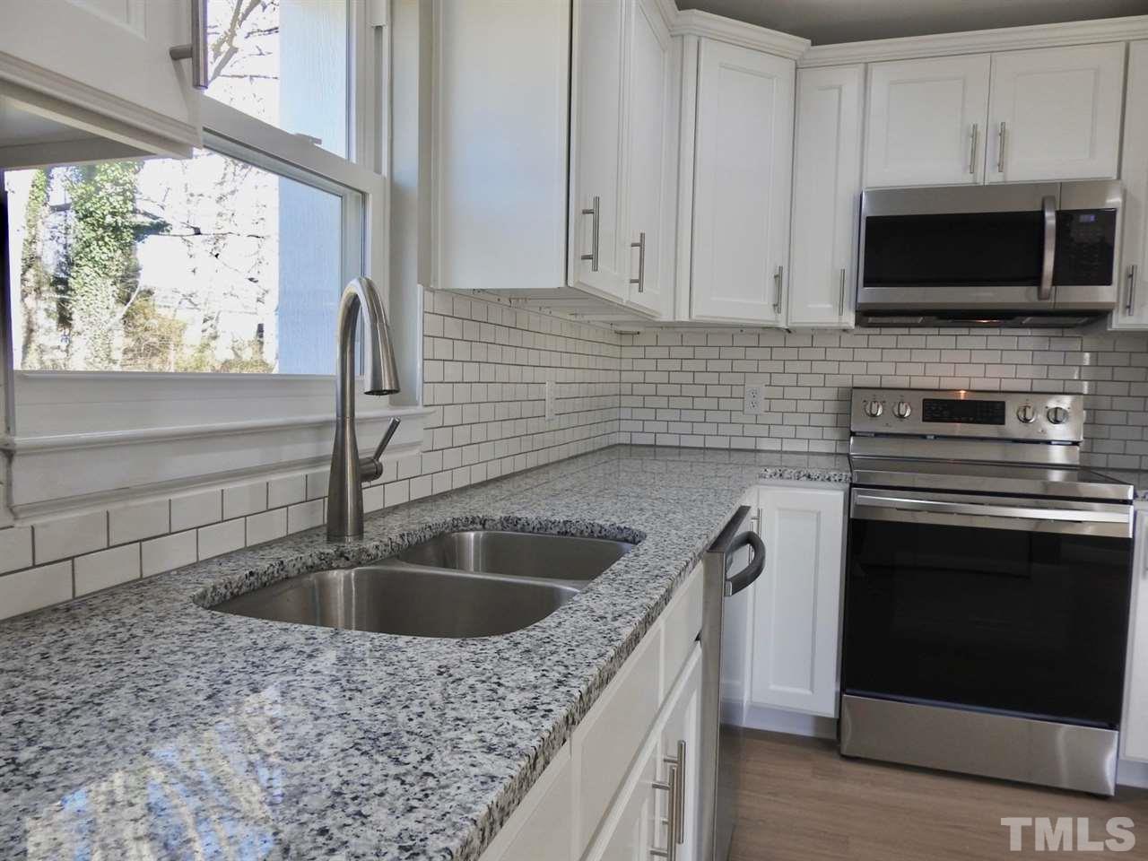 41 Peace Street Roxboro, NC 27573 - Photo 7 of 20 a kitchen with stainless steel appliances granite countertop a sink stove and microwave