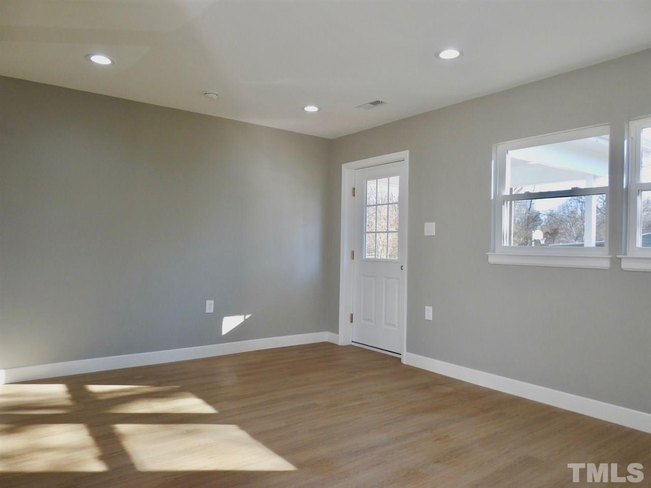 41 Peace Street Roxboro, NC 27573 - Photo 9 of 20 a view of empty room with wooden floor and fan