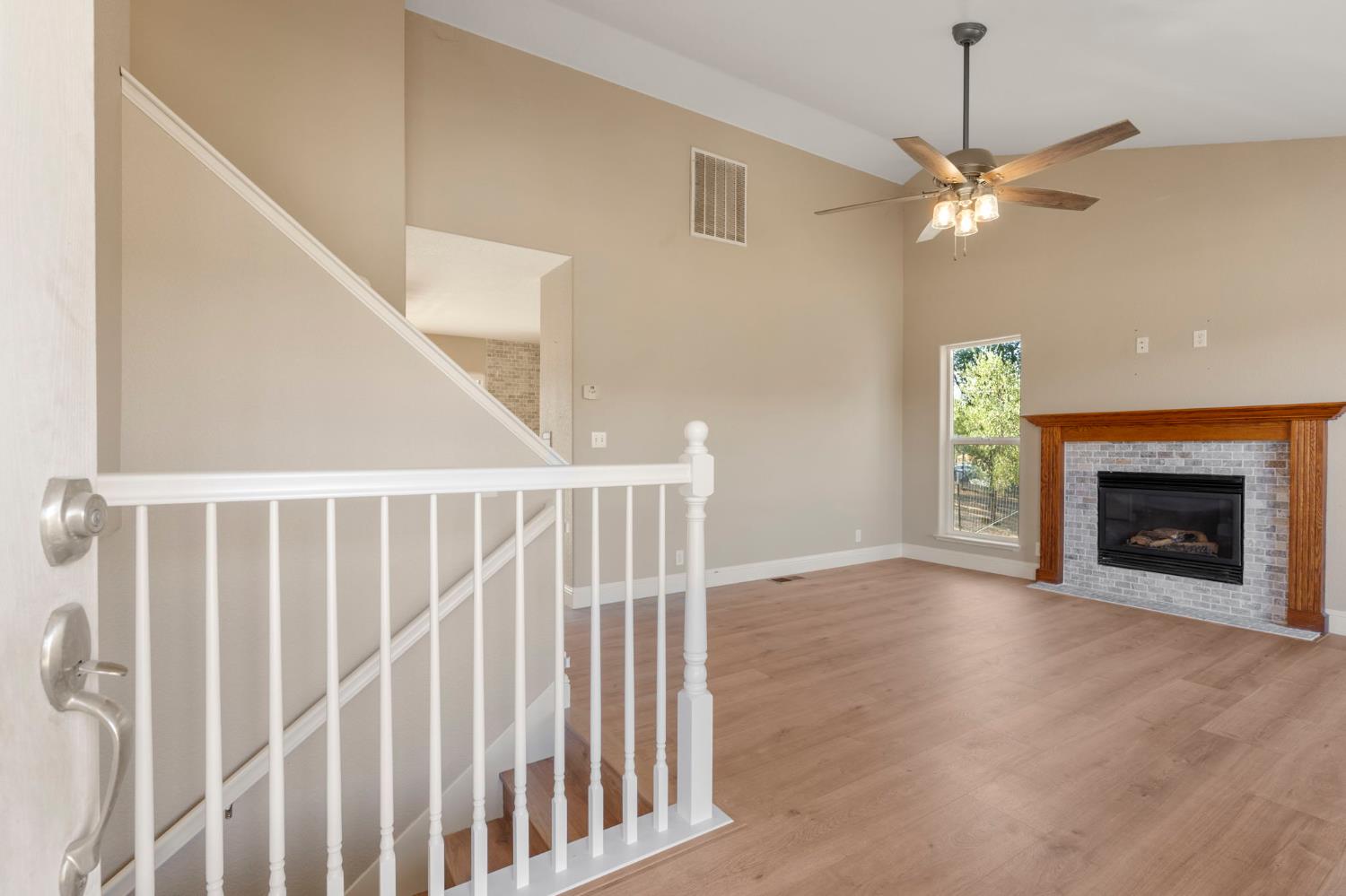 4068 Little John Road Copperopolis, CA 95228 - Photo 12 of 46 a view of an empty room with chandelier fan and fire place