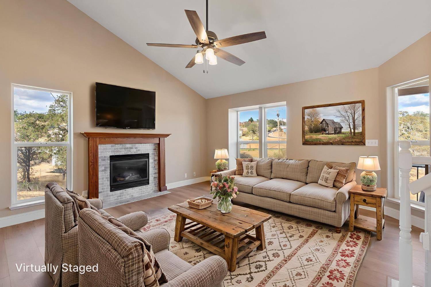 4068 Little John Road Copperopolis, CA 95228 - Photo 18 of 50 a living room with furniture a flat screen tv and a fireplace