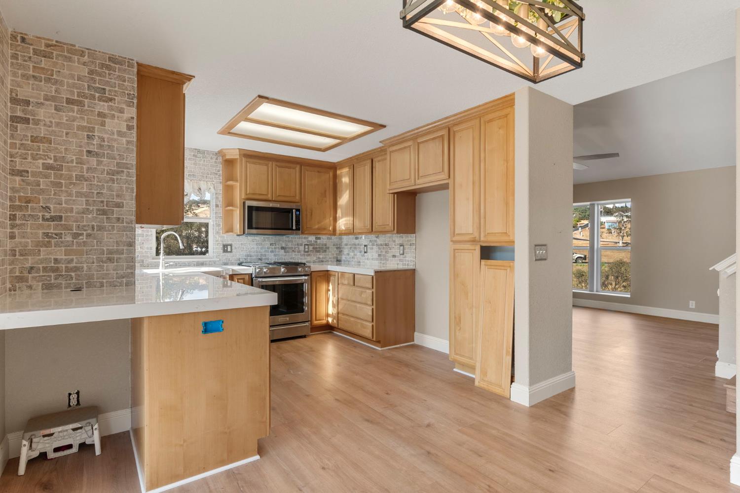 4068 Little John Road Copperopolis, CA 95228 - Photo 20 of 50 a kitchen with stainless steel appliances granite countertop a sink cabinets and wooden floor