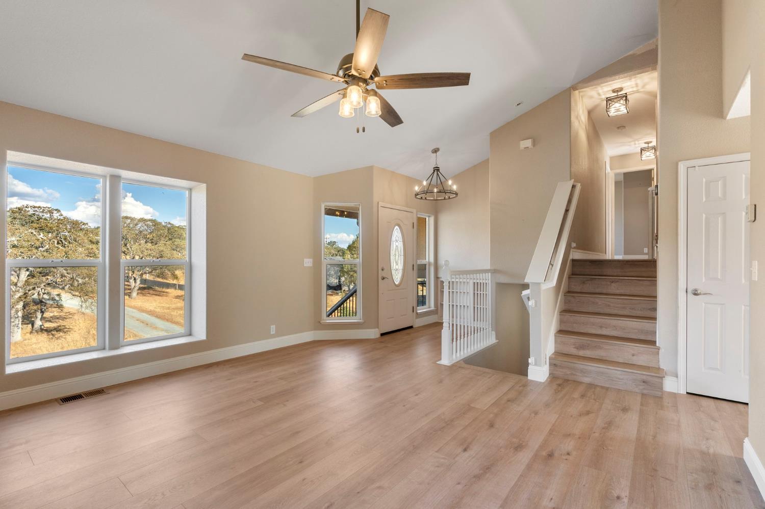 4068 Little John Road Copperopolis, CA 95228 - Photo 21 of 46 an empty room with wooden floor fan and windows