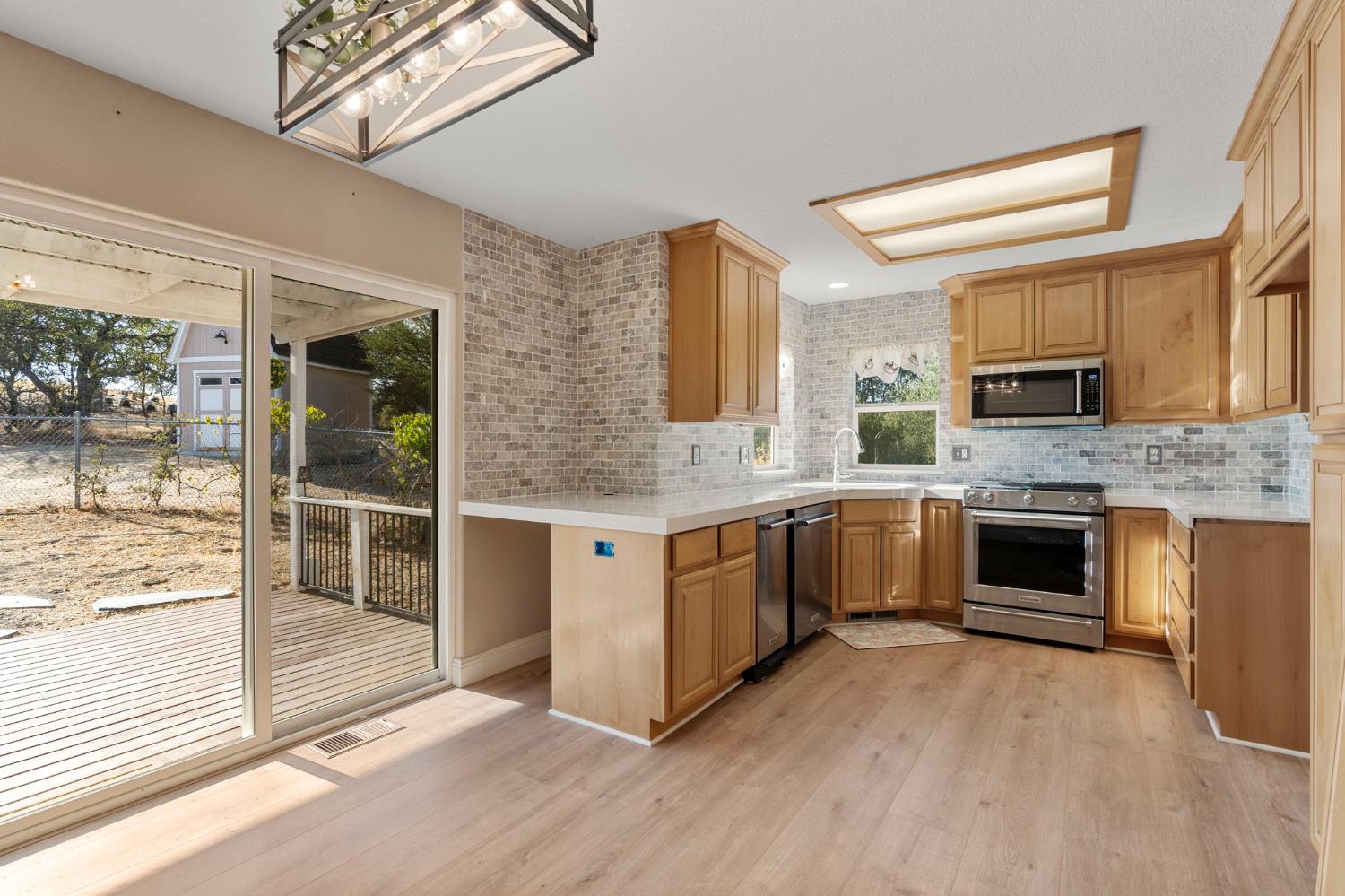 4068 Little John Road Copperopolis, CA 95228 - Photo 21 of 50 a kitchen with stainless steel appliances granite countertop a stove and cabinets