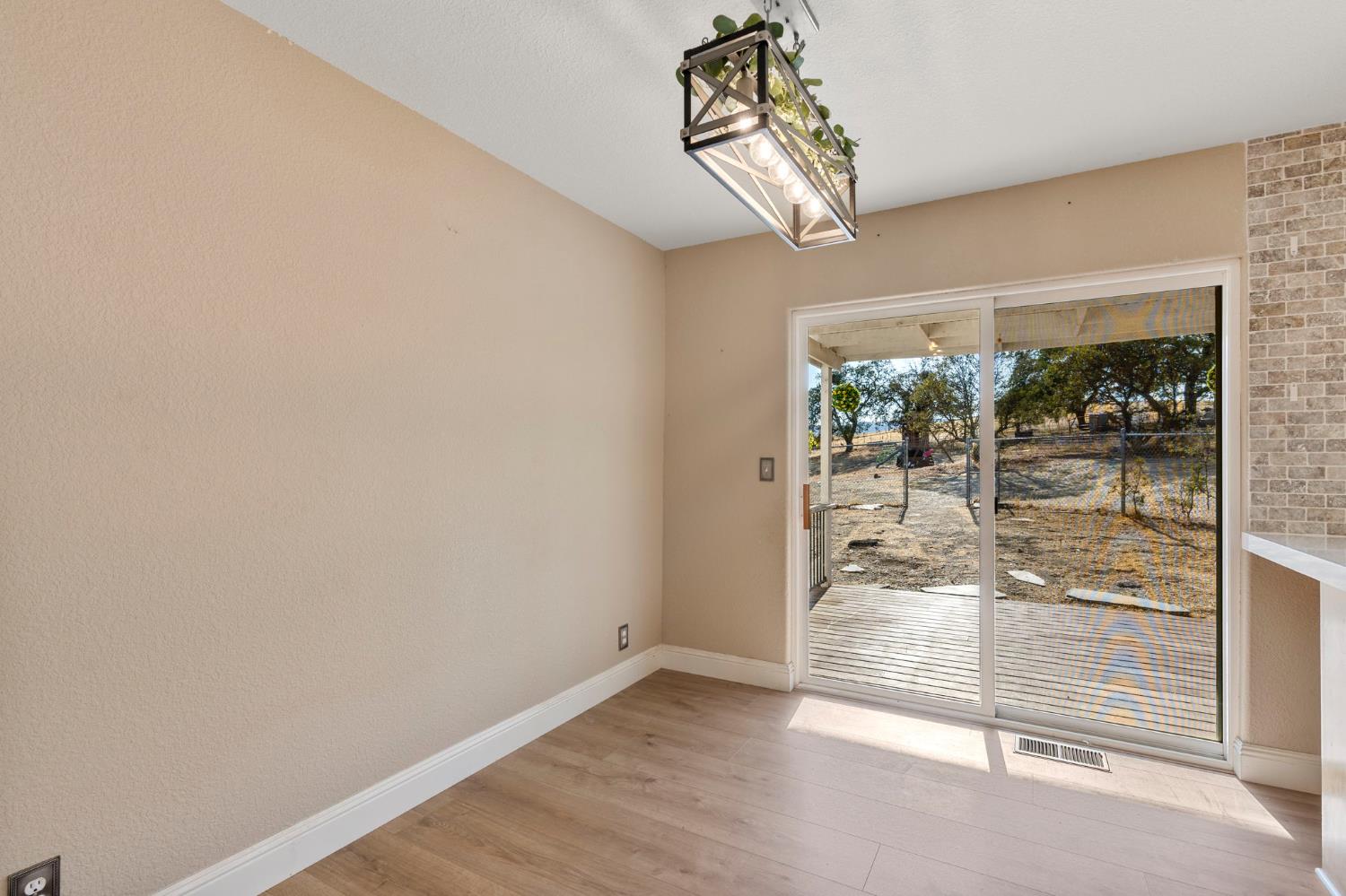 4068 Little John Road Copperopolis, CA 95228 - Photo 23 of 50 a view of a livingroom with wooden floor and a chandelier