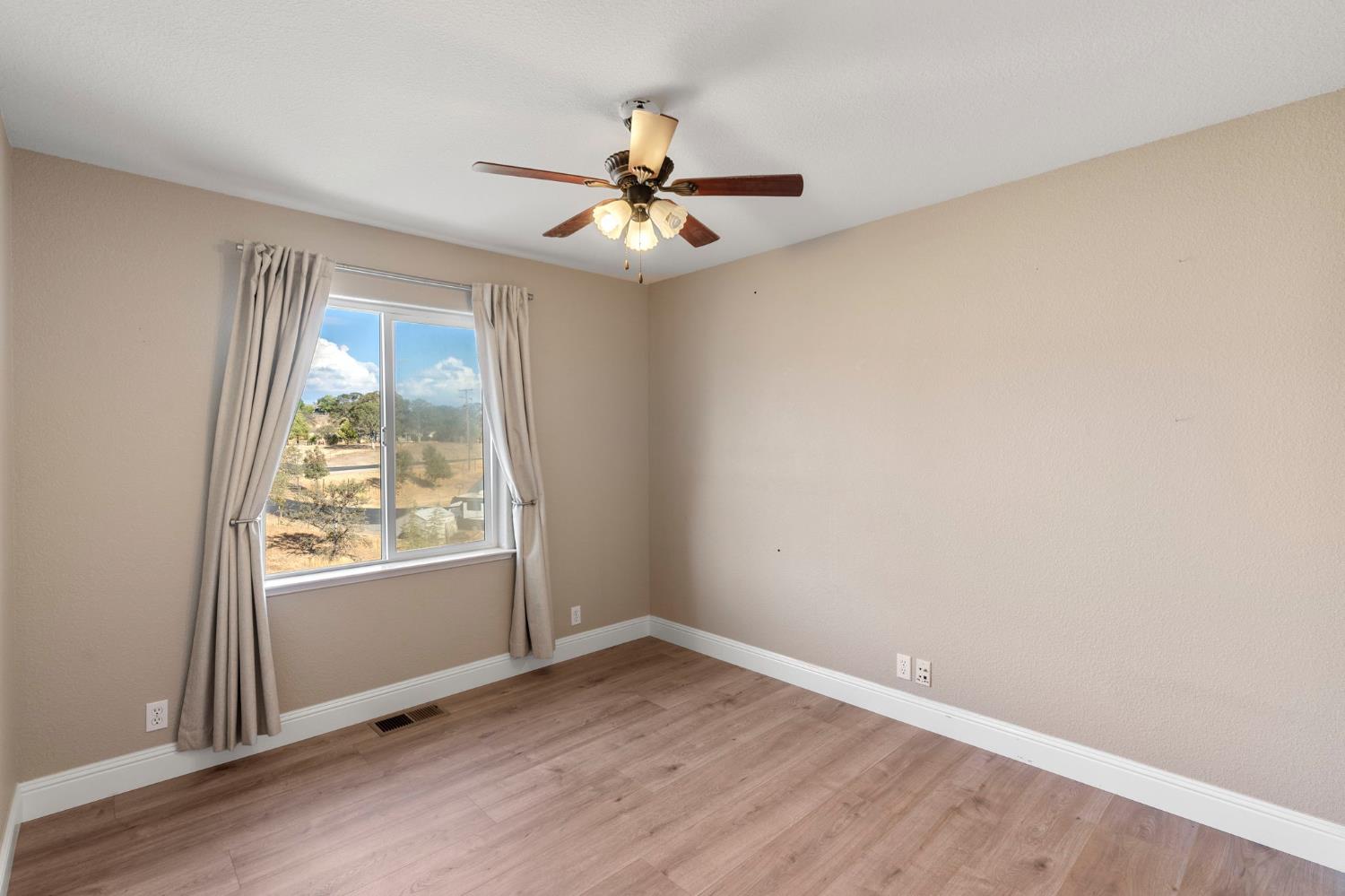 4068 Little John Road Copperopolis, CA 95228 - Photo 26 of 46 an empty room with windows and fan