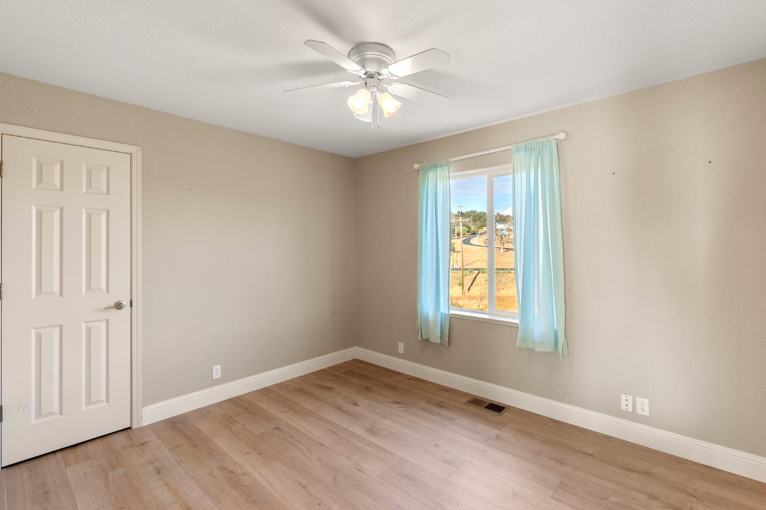 4068 Little John Road Copperopolis, CA 95228 - Photo 27 of 50 wooden floor in an empty room with a window