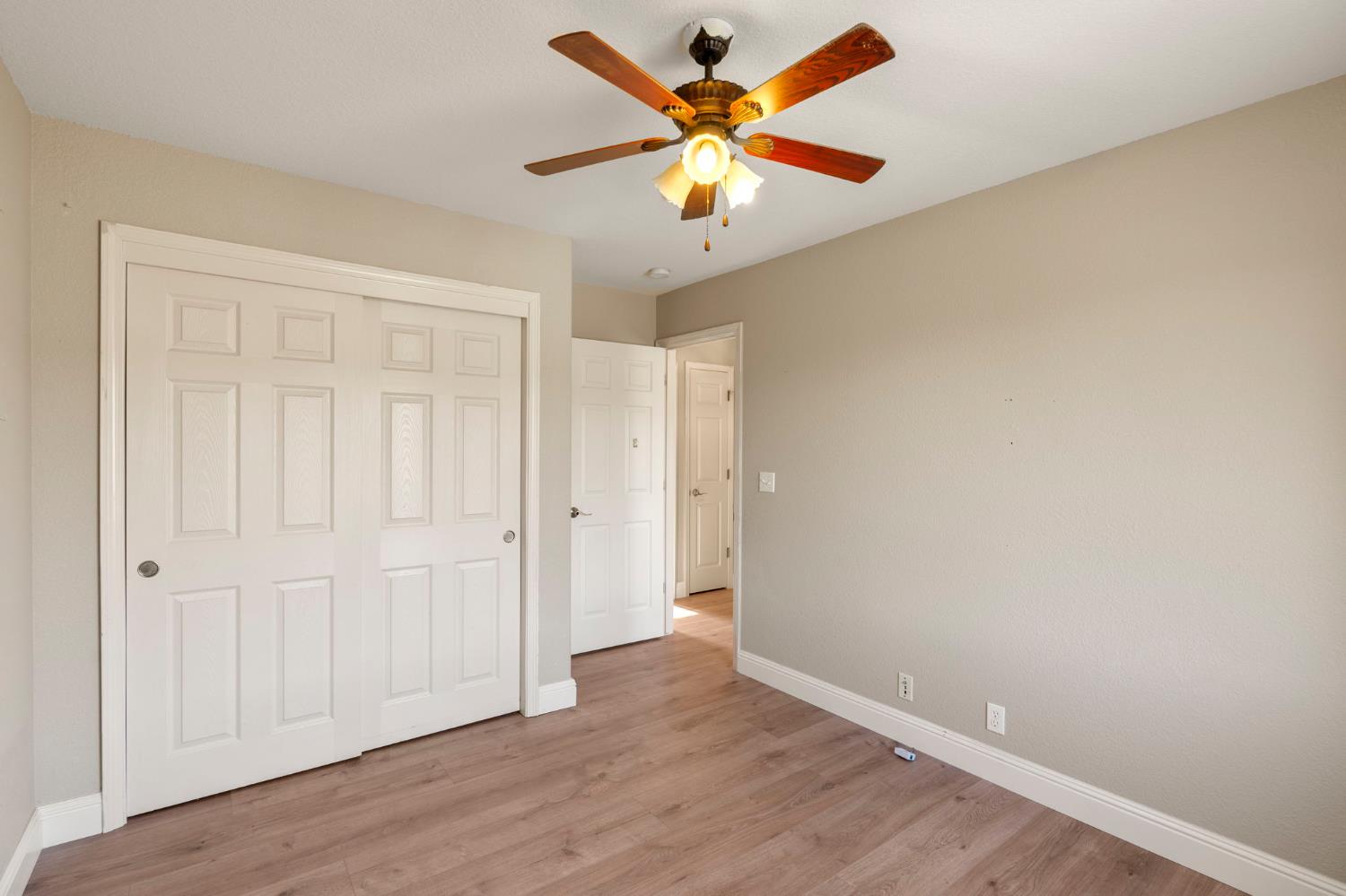 4068 Little John Road Copperopolis, CA 95228 - Photo 28 of 46 an empty room with wooden floor and windows