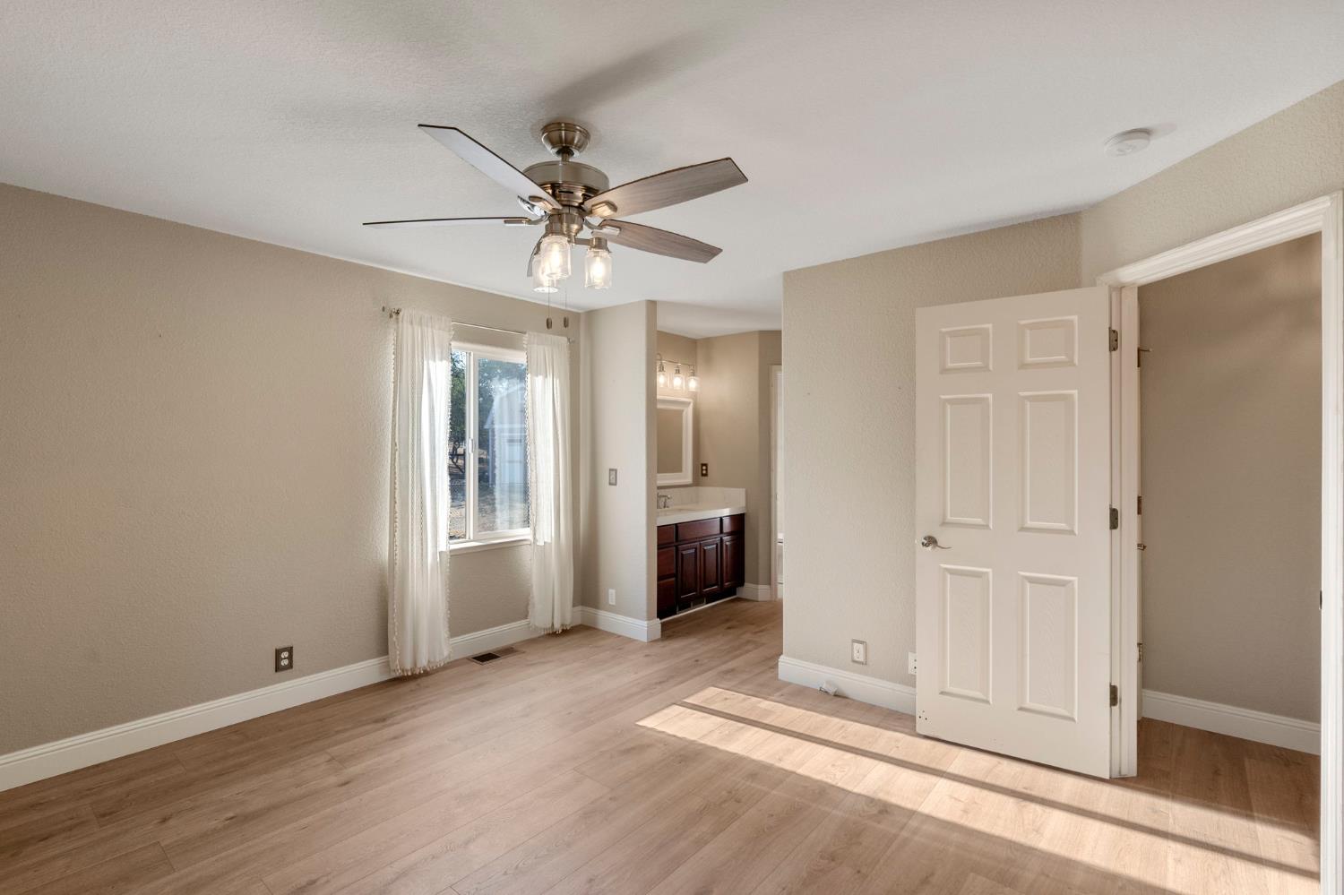 4068 Little John Road Copperopolis, CA 95228 - Photo 33 of 50 a view of a livingroom with a chandelier fan and windows