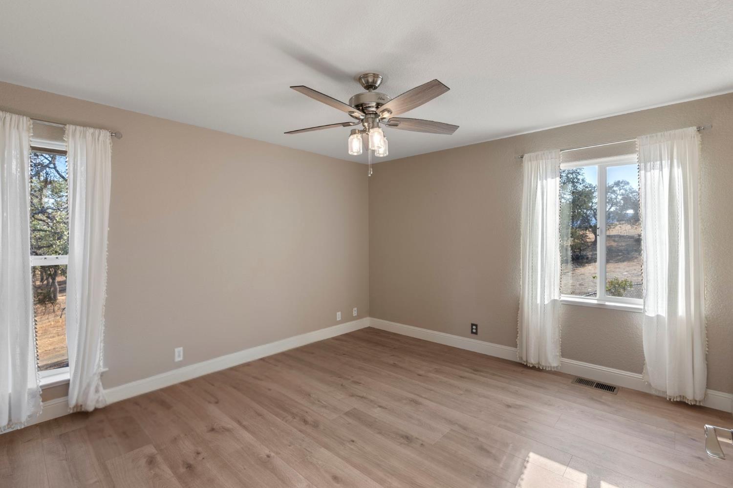 4068 Little John Road Copperopolis, CA 95228 - Photo 36 of 50 wooden floor in an empty room with a window