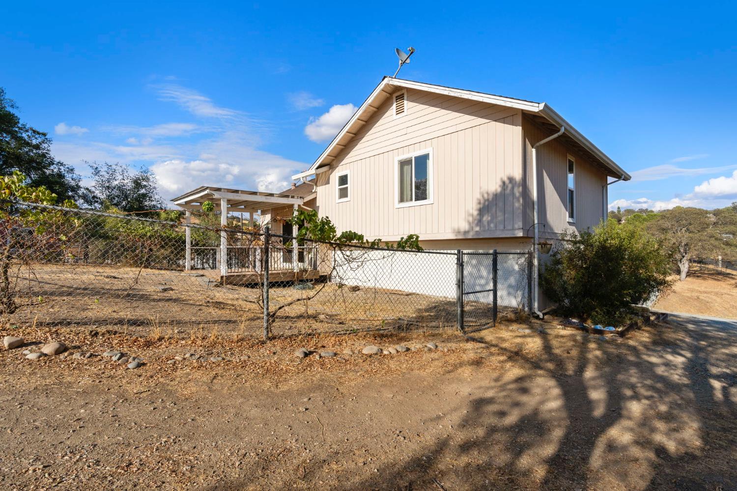 4068 Little John Road Copperopolis, CA 95228 - Photo 47 of 50 a view of a house with backyard and sitting area