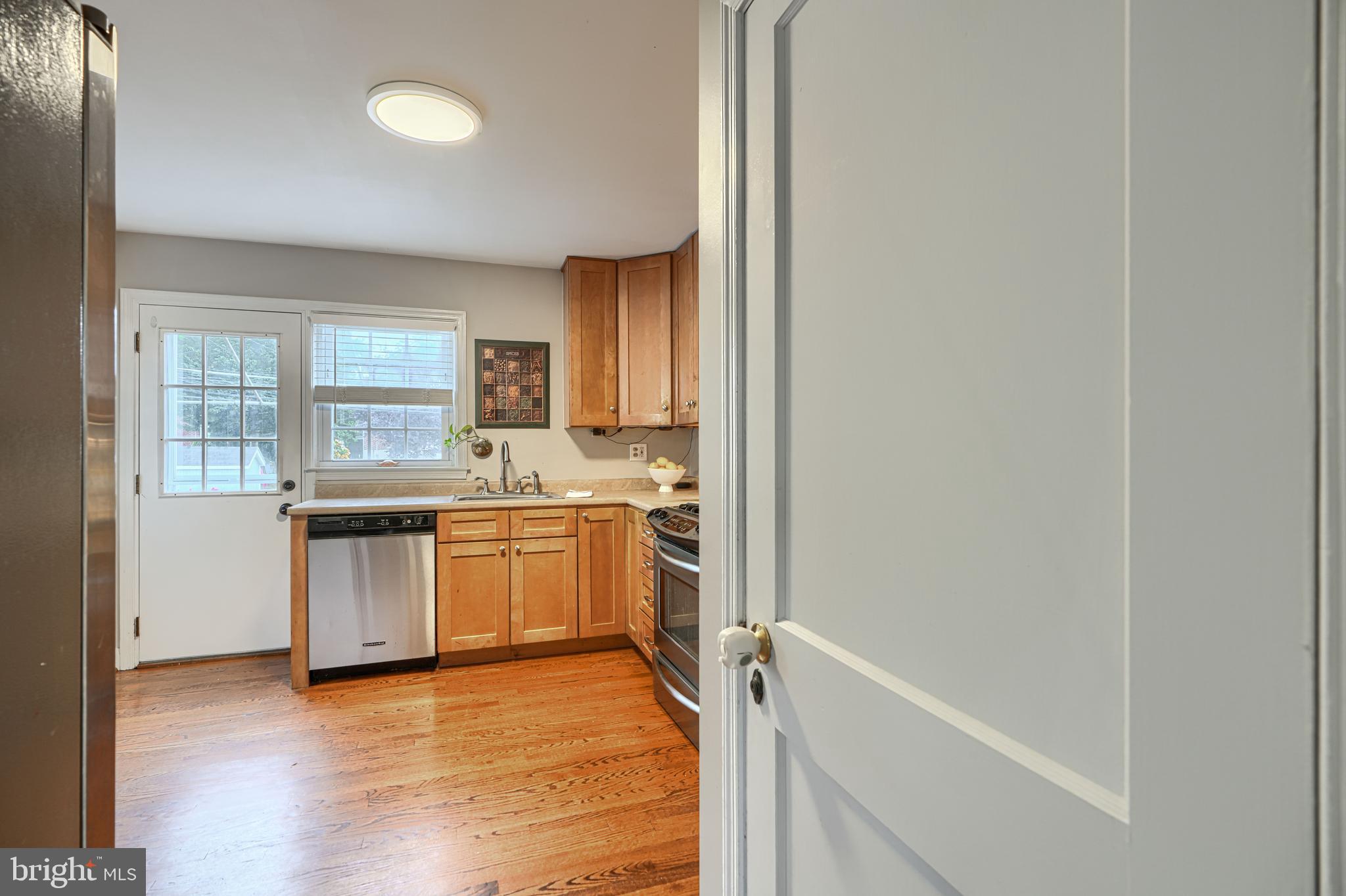 8132 Pleasant Plains Road Towson, MD 21286 - Photo 18 of 55 a kitchen with a refrigerator and a stove top oven