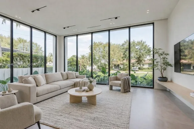a living room with furniture and a large window