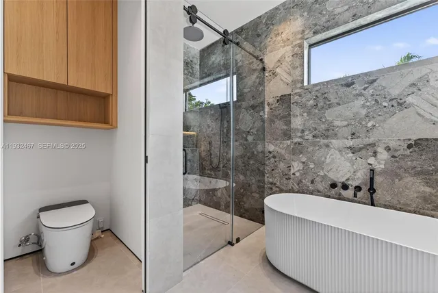 a bathroom with a toilet and a shower