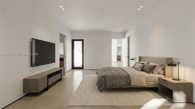 a spacious bedroom with a bed and a flat screen television