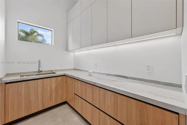 a kitchen with a sink and cabinets