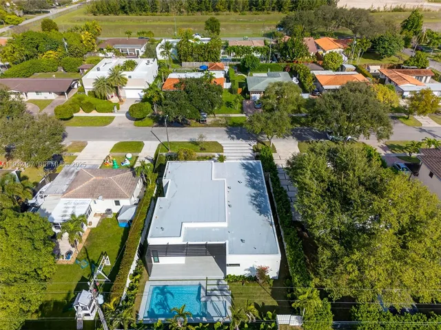 an aerial view of multiple houses with yard