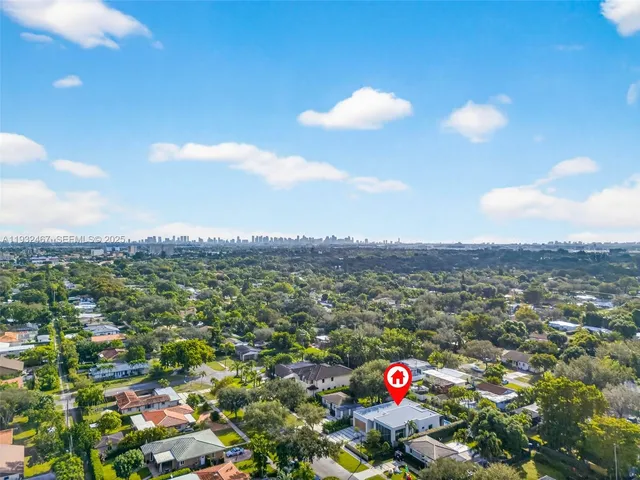 a view of a house with a garden and pathway