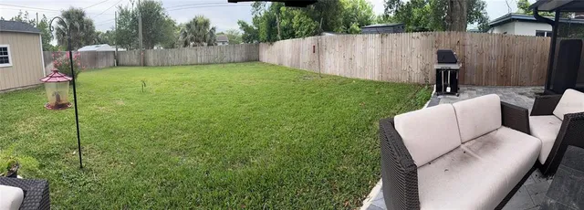 a view of backyard with tub and trees