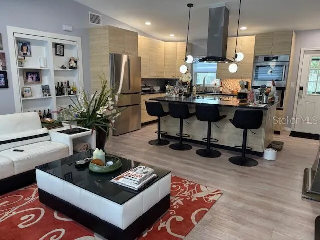 a kitchen with a table chairs stove and kitchen view