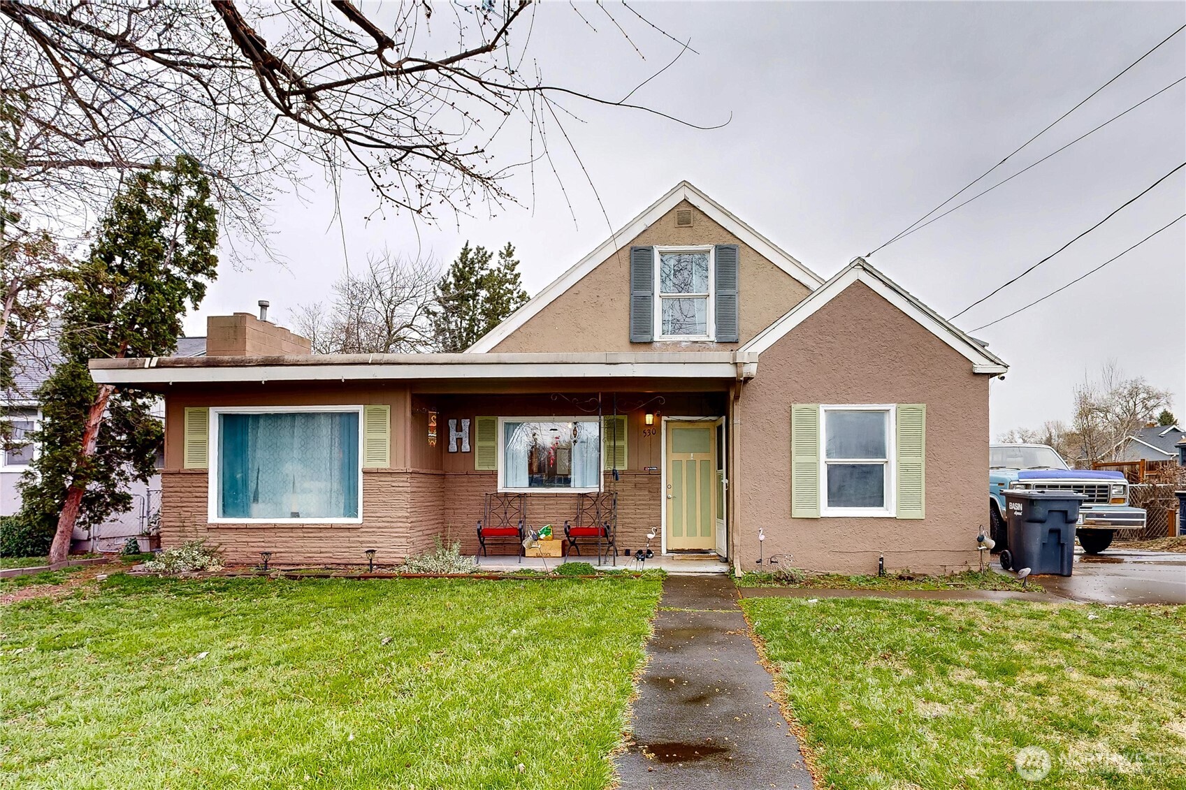 a front view of house with yard and outdoor seating