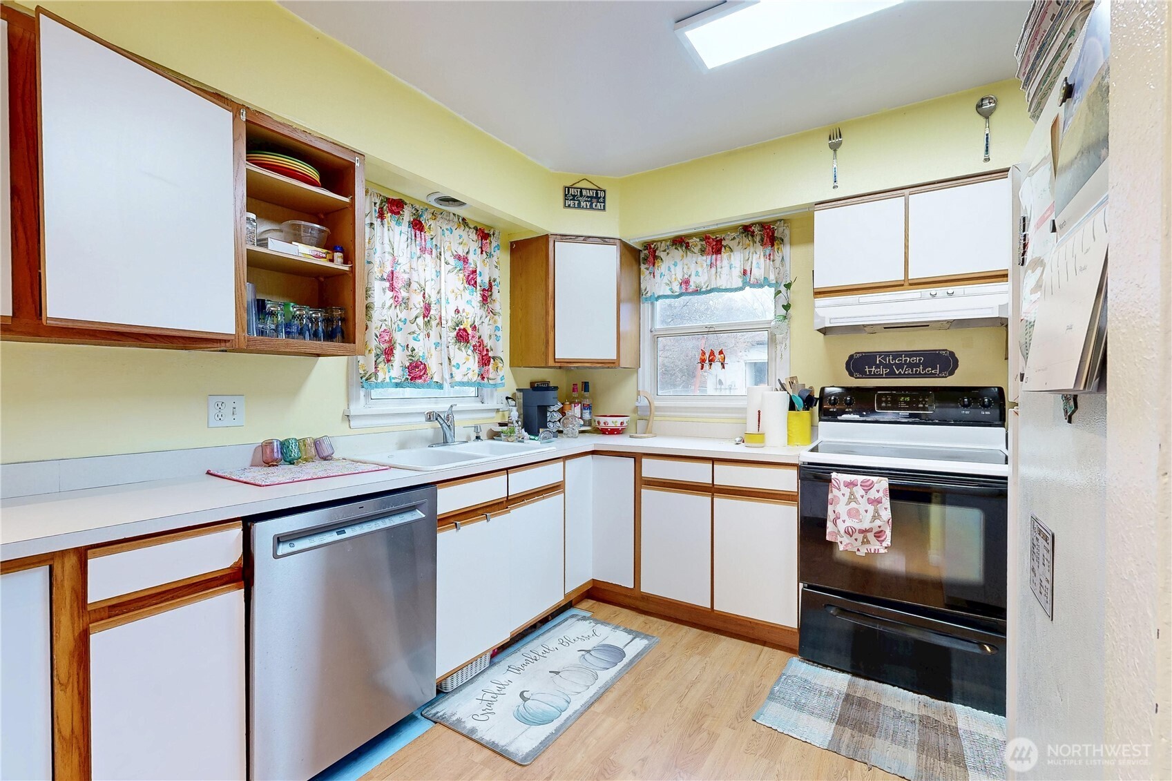 530 Southwest 4th Street College Place, WA 99324 - Photo 11 of 30 a kitchen with stainless steel appliances a sink cabinets and a window
