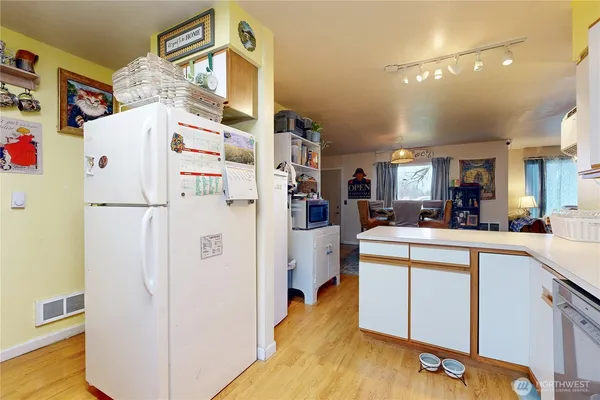 a kitchen with a refrigerator a stove and cabinets