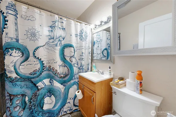 a bathroom with a sink mirror vanity and toilet