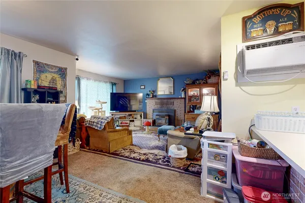 a living room with furniture fireplace and a window