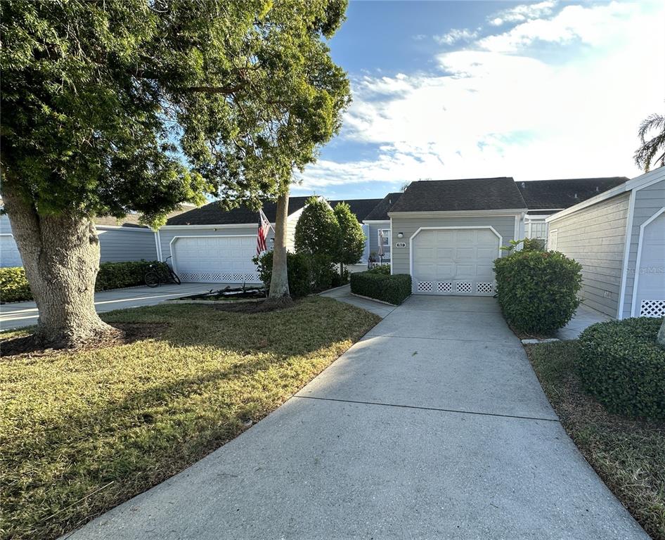 517 Woodstork Circle Bradenton, FL 34209 - Photo 1 of 34 a front view of a house with a yard garage and outdoor seating