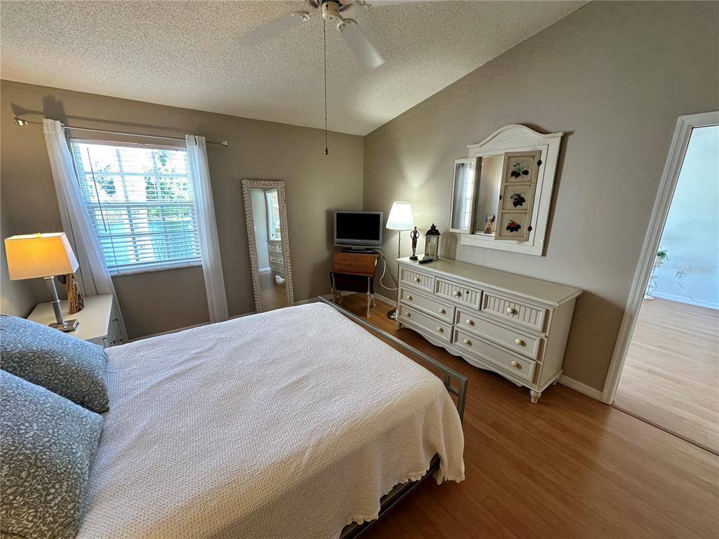 517 Woodstork Circle Bradenton, FL 34209 - Photo 12 of 34 a bedroom with a bed and wooden floor