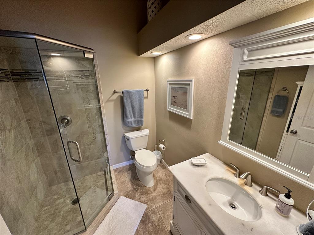 517 Woodstork Circle Bradenton, FL 34209 - Photo 14 of 34 a bathroom with a sink toilet and shower