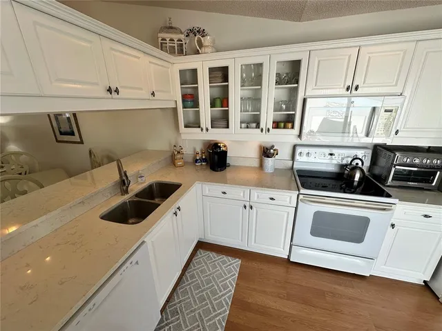 a kitchen that has a sink and a stove