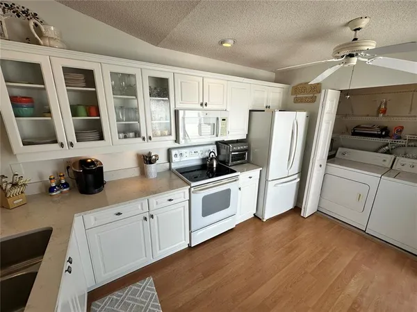 a kitchen with stainless steel appliances a refrigerator sink and cabinets