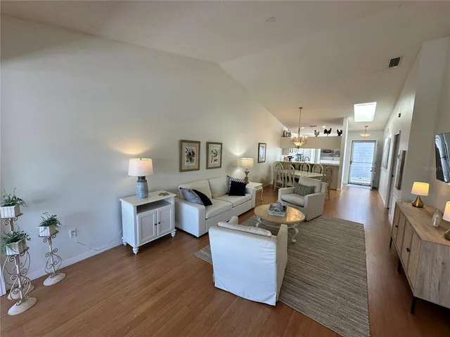 a living room with fireplace furniture and a wooden floor