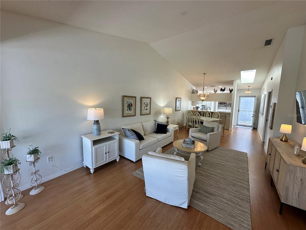 517 Woodstork Circle Bradenton, FL 34209 - Photo 6 of 34 a living room with fireplace furniture and a wooden floor