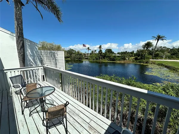 a view of a balcony with wooden floor and outdoor space