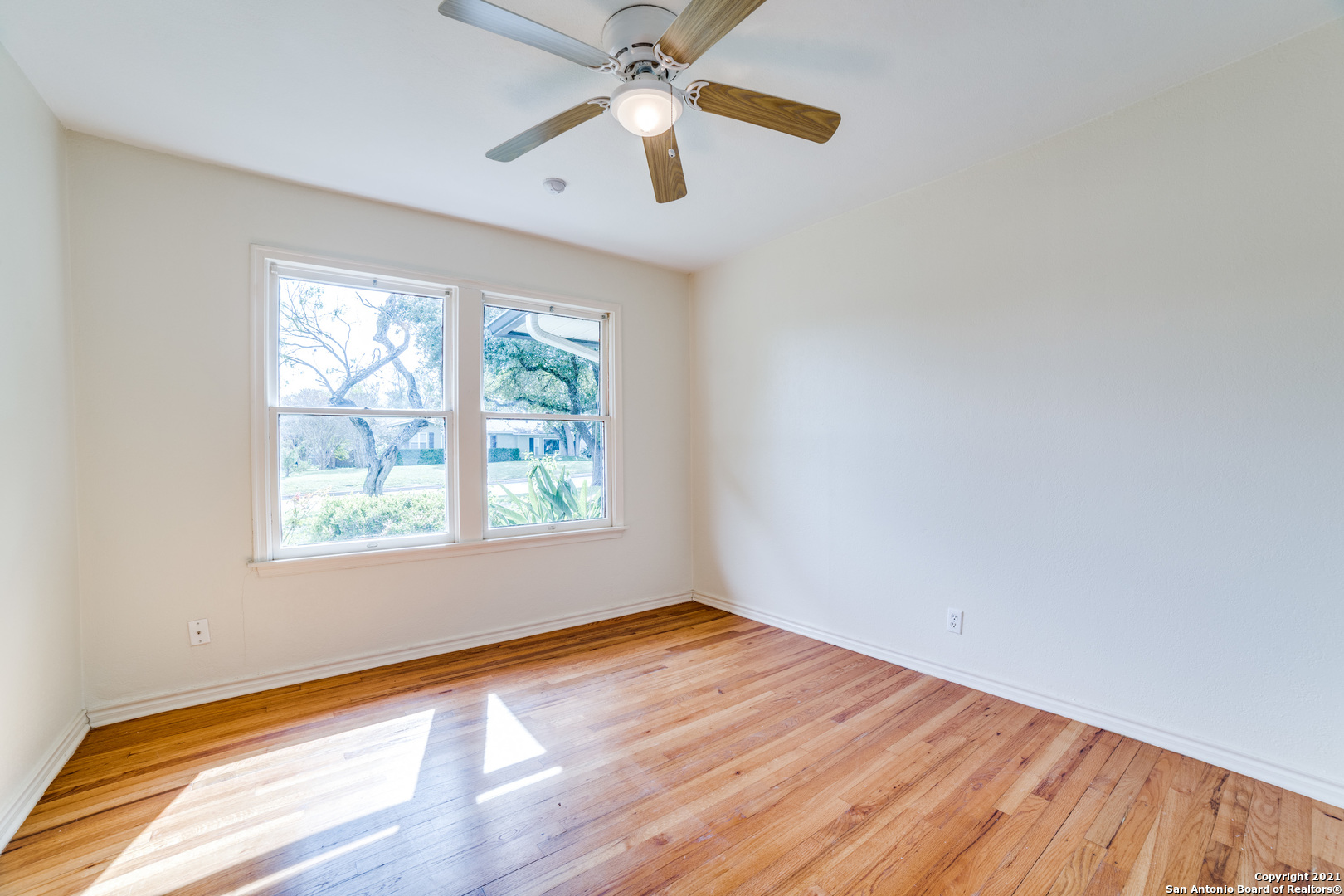 1149 Garraty Road San Antonio, TX 78209 - Photo 15 of 25 wooden floor in an empty room with a window