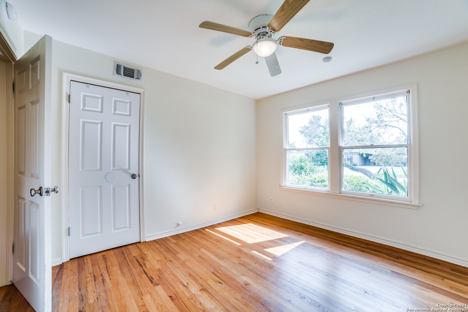 1149 Garraty Road San Antonio, TX 78209 - Photo 16 of 25 wooden floor in an empty room with a window