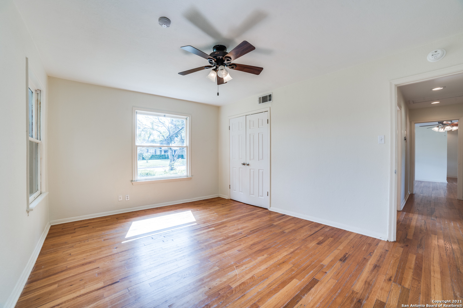 1149 Garraty Road San Antonio, TX 78209 - Photo 17 of 25 a view of empty room with wooden floor and fan
