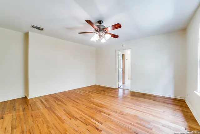 a spacious bathroom with a tub sink and mirror