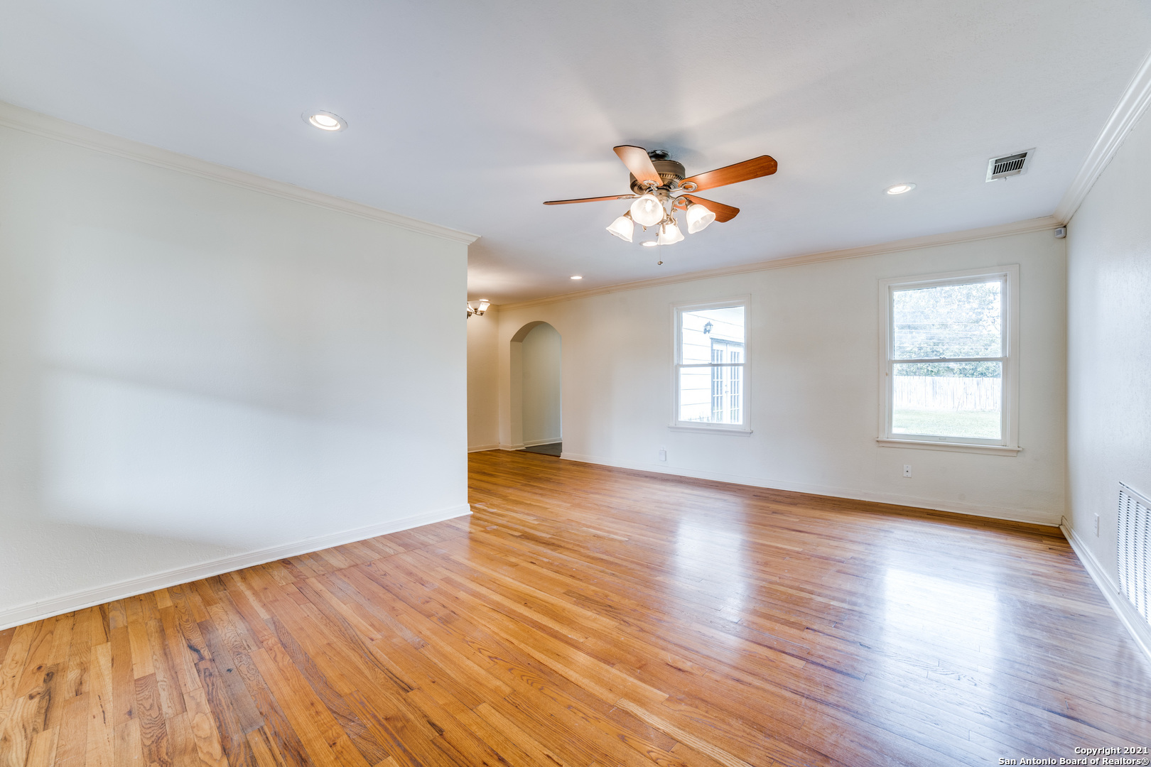 1149 Garraty Road San Antonio, TX 78209 - Photo 4 of 25 a view of an empty room with window and wooden floor