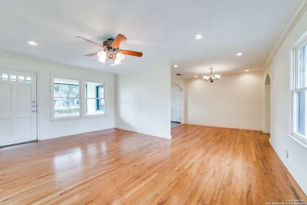 a view of a kitchen with wooden floor and a large window
