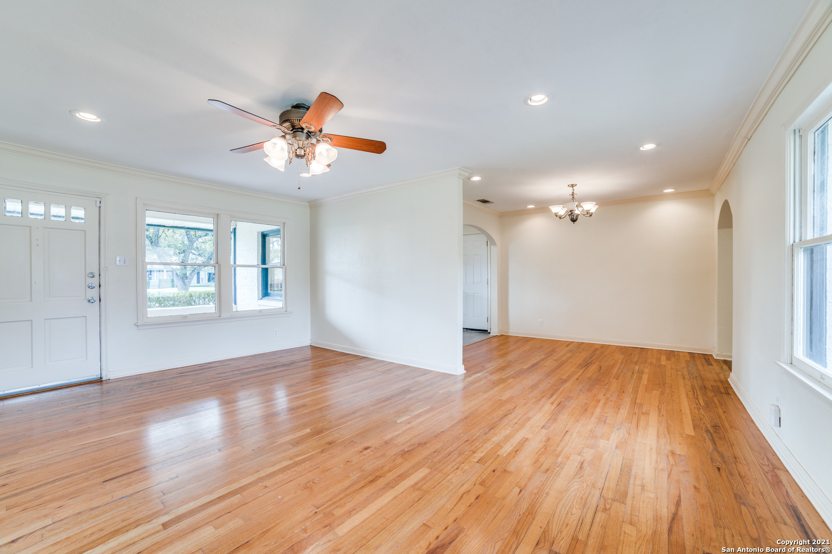 1149 Garraty Road San Antonio, TX 78209 - Photo 5 of 25 a view of an empty room with a window and wooden floor
