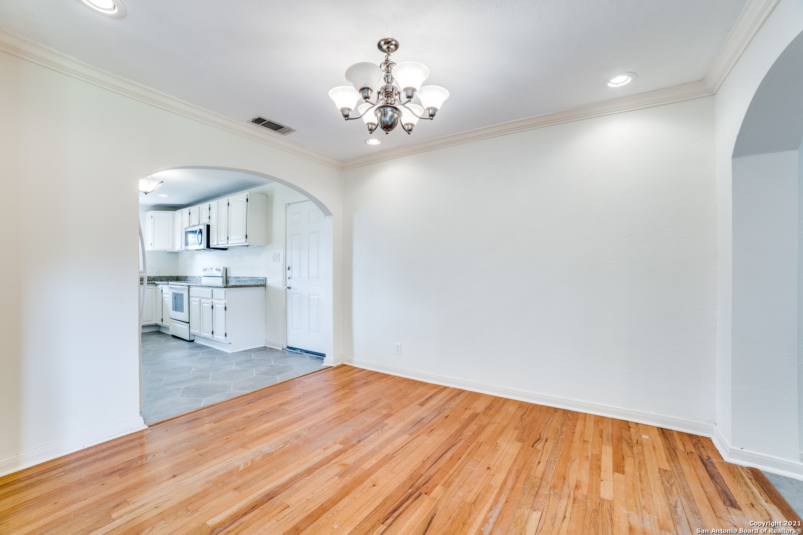 1149 Garraty Road San Antonio, TX 78209 - Photo 6 of 25 a view of a kitchen with wooden floor and a large window