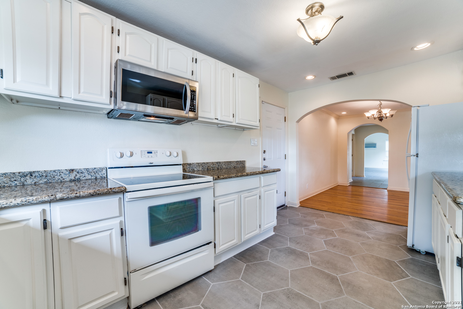 1149 Garraty Road San Antonio, TX 78209 - Photo 9 of 25 a kitchen with stainless steel appliances granite countertop a stove a sink and a microwave