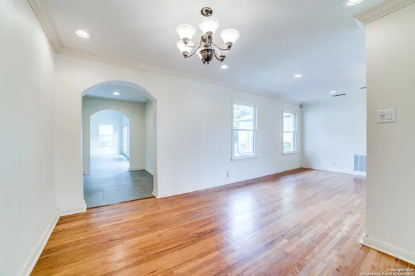 a view of a hallway view with wooden floor and staircase